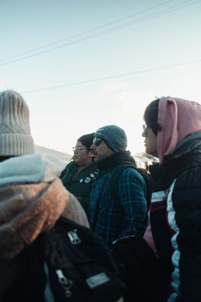 Group of adults in winter clothing gathered outdoors in a rural community, representing DHJ Services’ community outreach and commitment to equitable healthcare solutions.